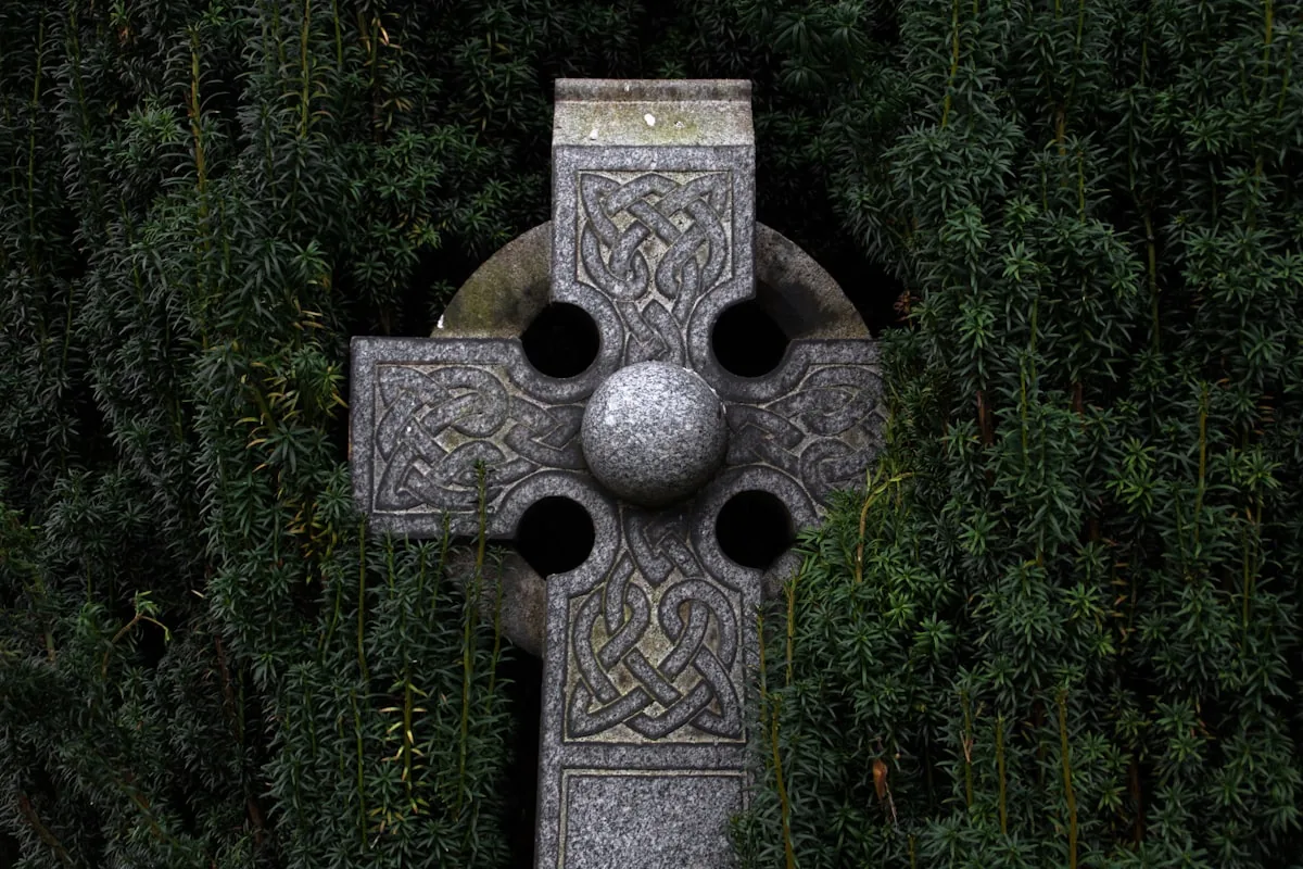 Celtic Love Knot in burnished gold, two intertwined ropes forming a heart-shaped continuous pattern