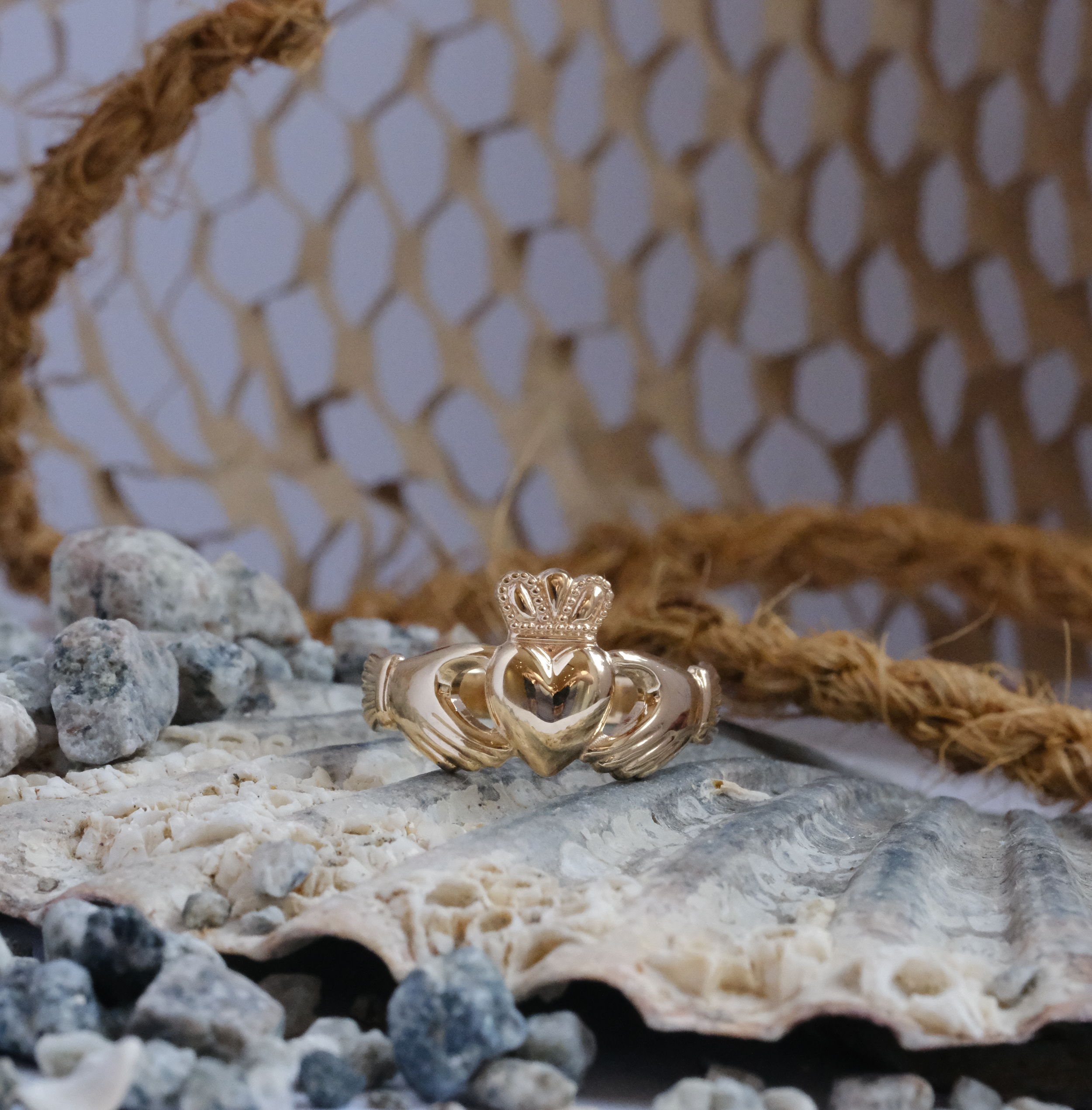 14K yellow gold Claddagh ring — heart, crown, and clasped hands on a polished gold band
