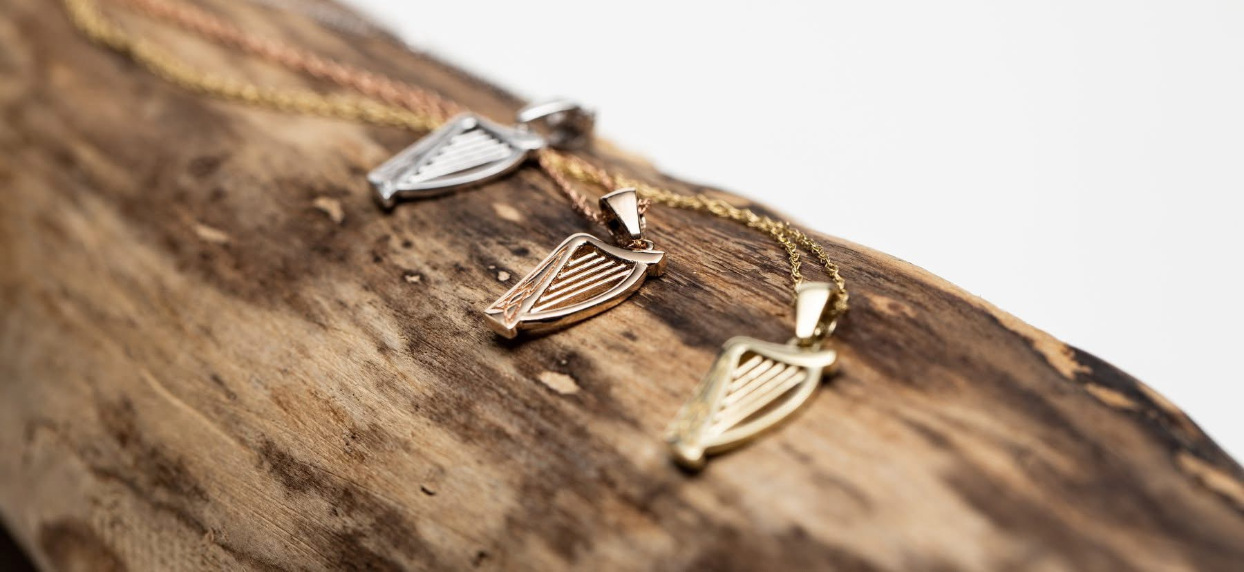 Gold Claddagh pendant necklace — heart, hands, and crown on a fine gold chain